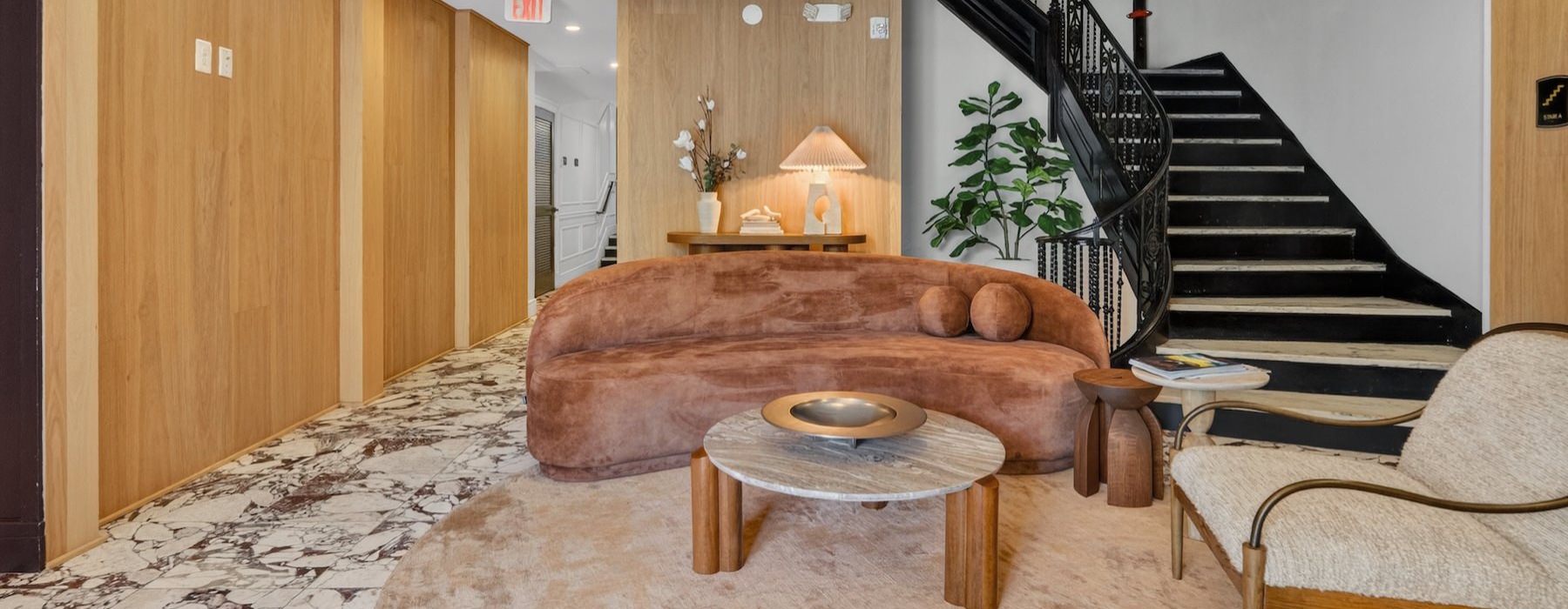 a clubroom with a chair, couch and a coffee table