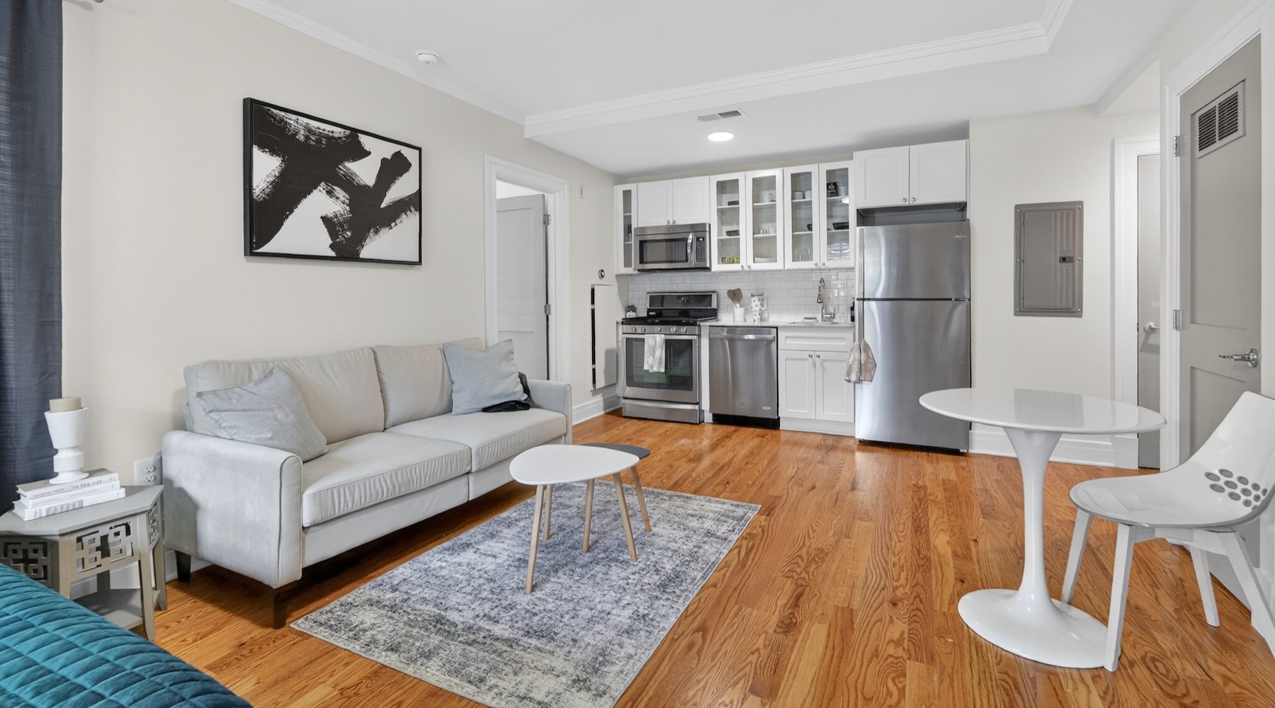 a living room with a couch, tables and a chair