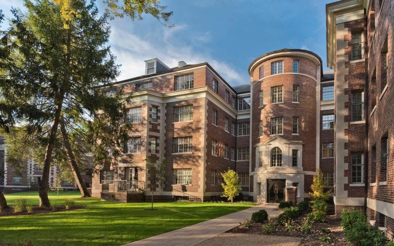 a building with a lawn and trees