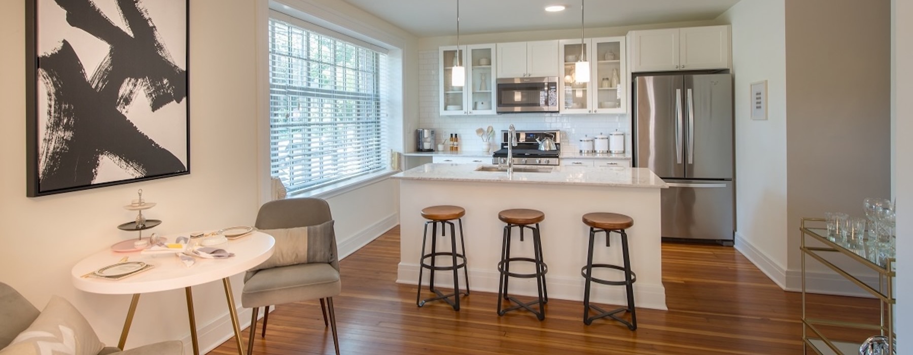 a kitchen with stools and a table