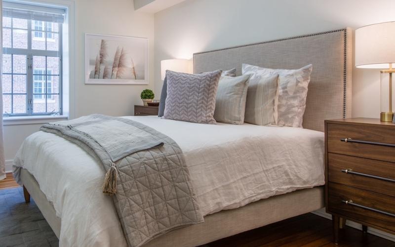 a bedroom with a bed and two nightstands